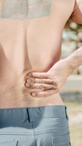 man holding his low back pain